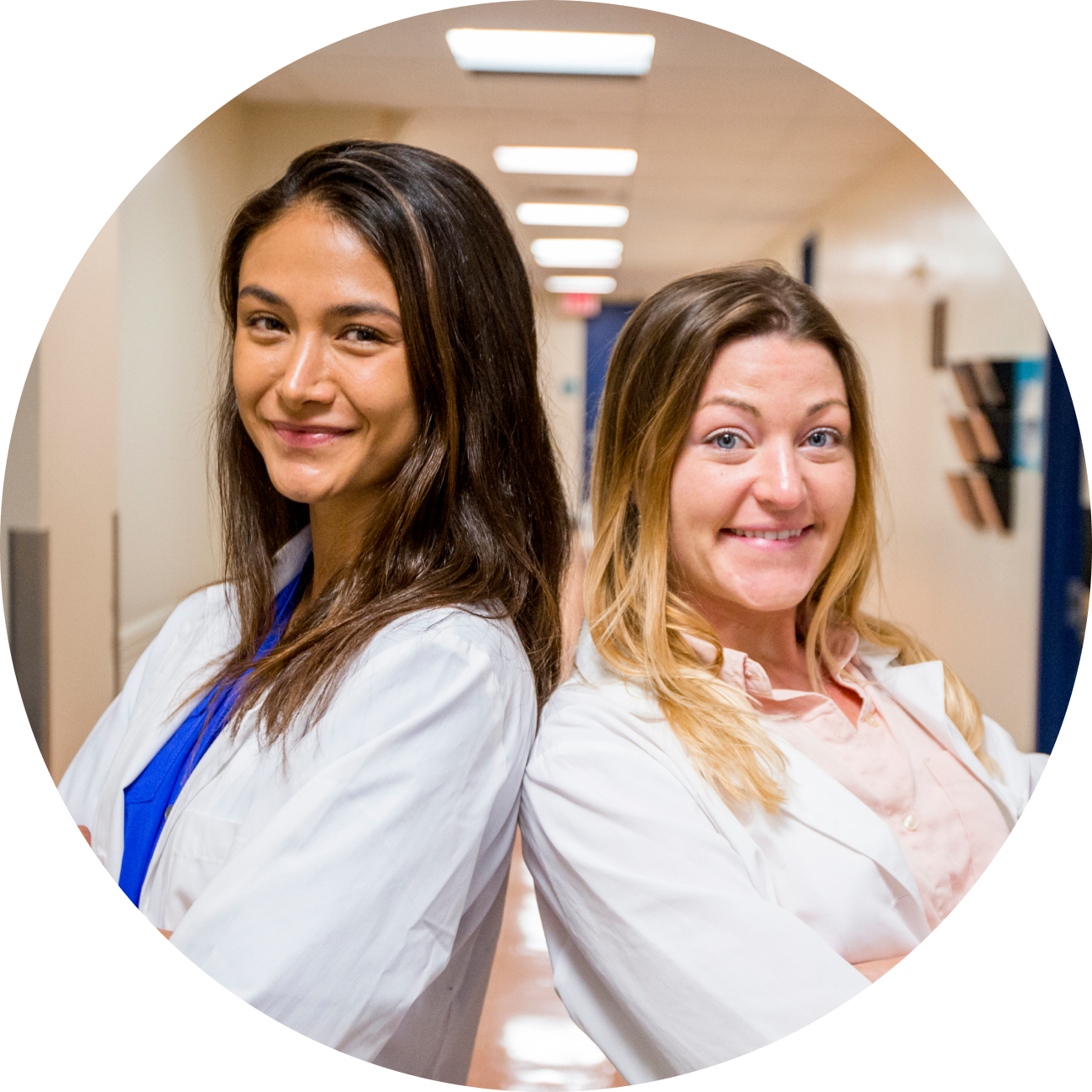 two students smiling in hallway