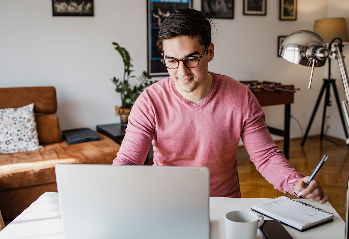 male student working on laptop at home.