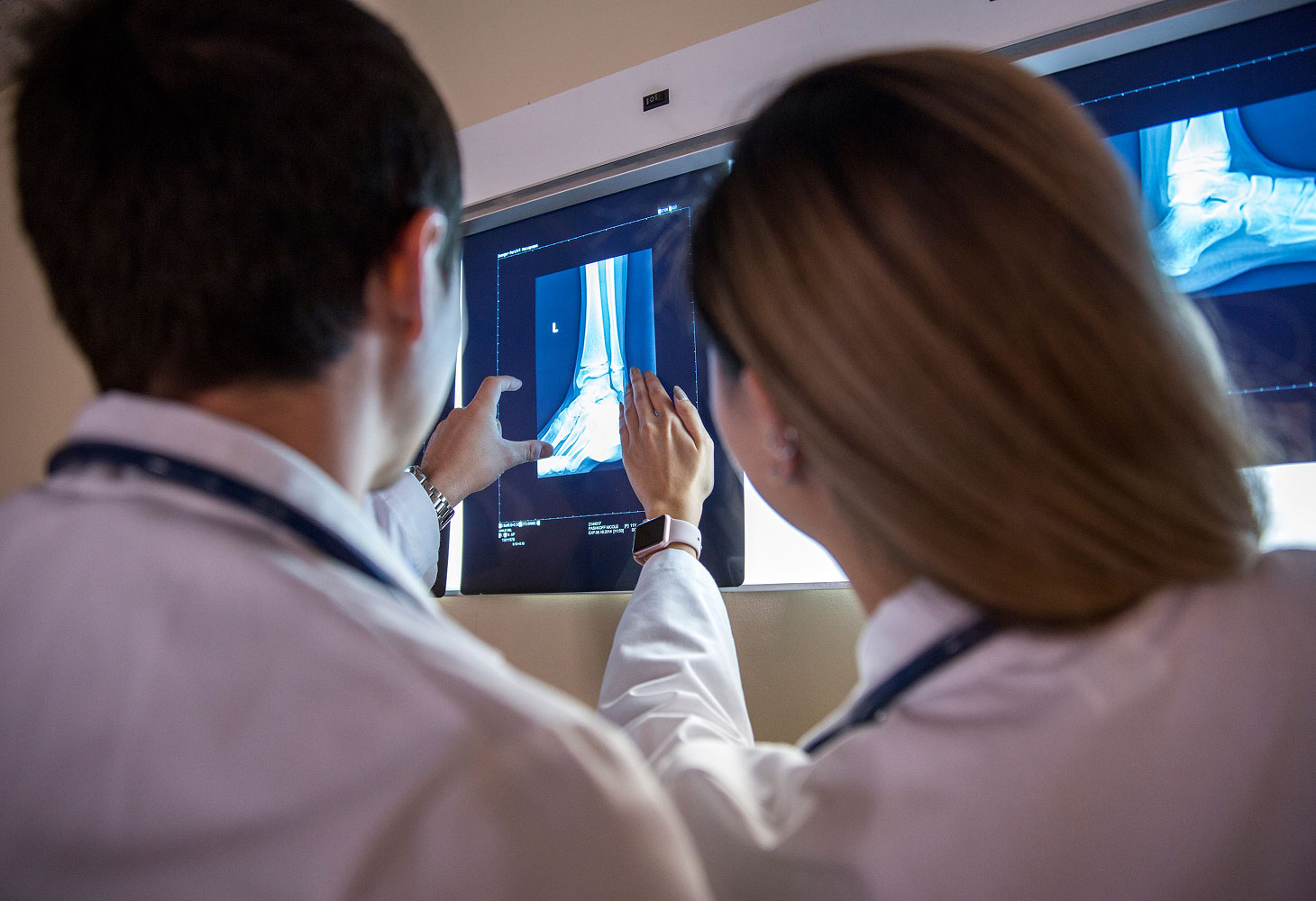 two PA students looking at x-ray during rotations.