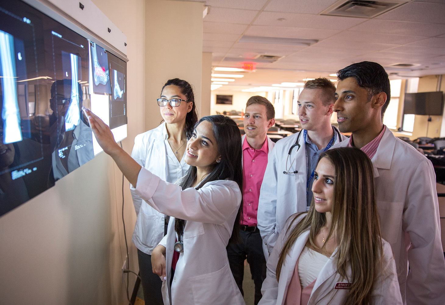 PA students looking at x rays on screen.